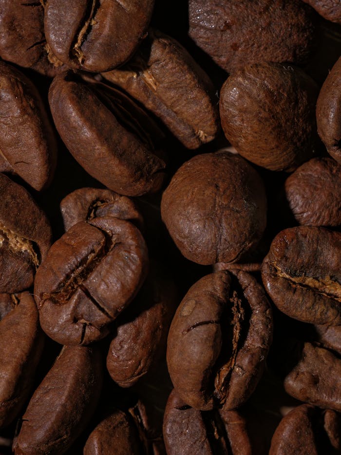 about-02 Detailed macro shot of roasted coffee beans showing rich textures and earthy tones.