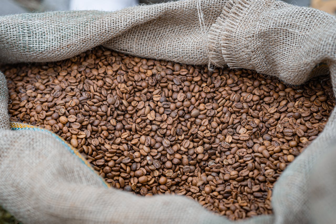 services-img A close-up of freshly roasted coffee beans in a burlap sack, perfect for coffee lovers.